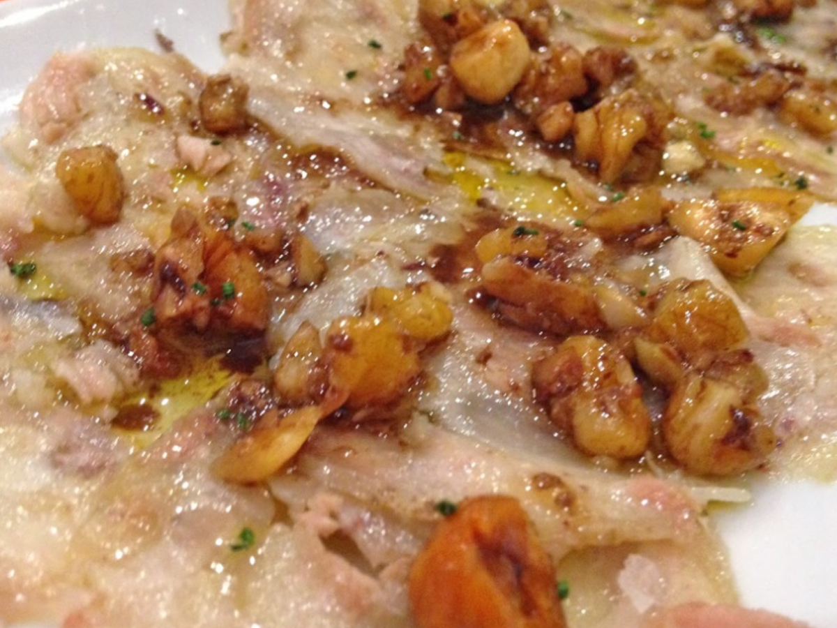 Pork leg carpaccio with nuts