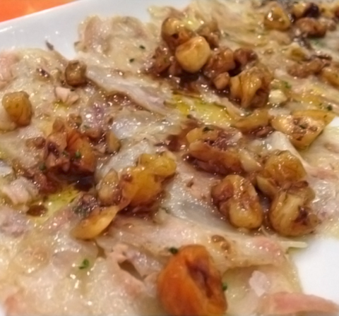 Pork leg carpaccio with nuts